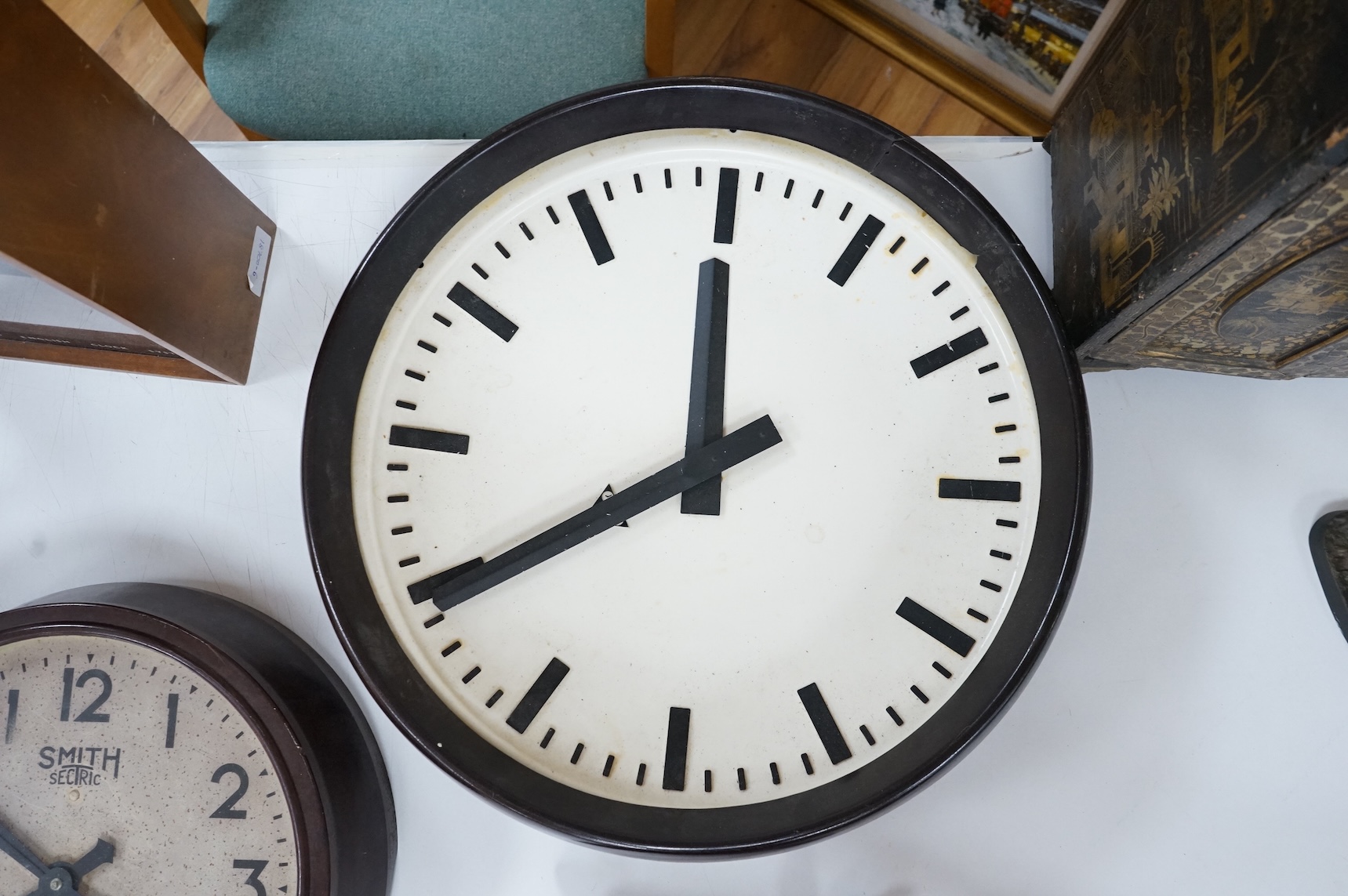 Two 20th century electric wall clocks, including a Smith’s Bakelite example, largest 47cm diameter